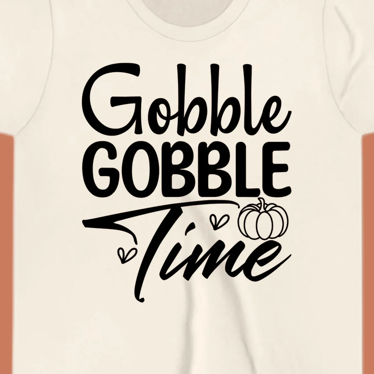 Gobble Gobble Time phrase with pumpkin and hearts, white typography on black background.