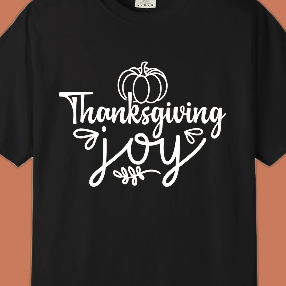 Thanksgiving Joy script text with a pumpkin illustration, for gratitude tees.