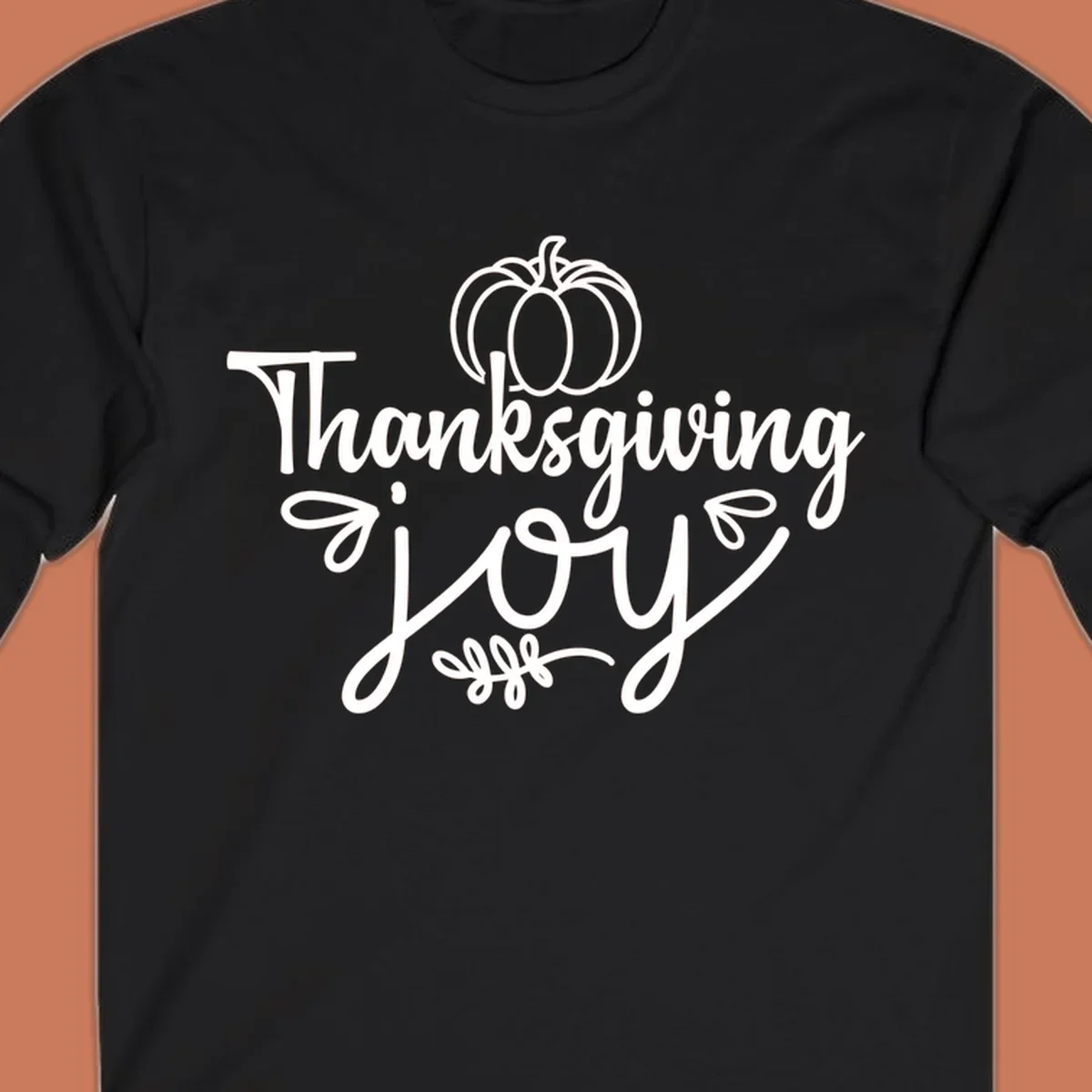 Thanksgiving Joy script text with a pumpkin illustration, for gratitude tees.
