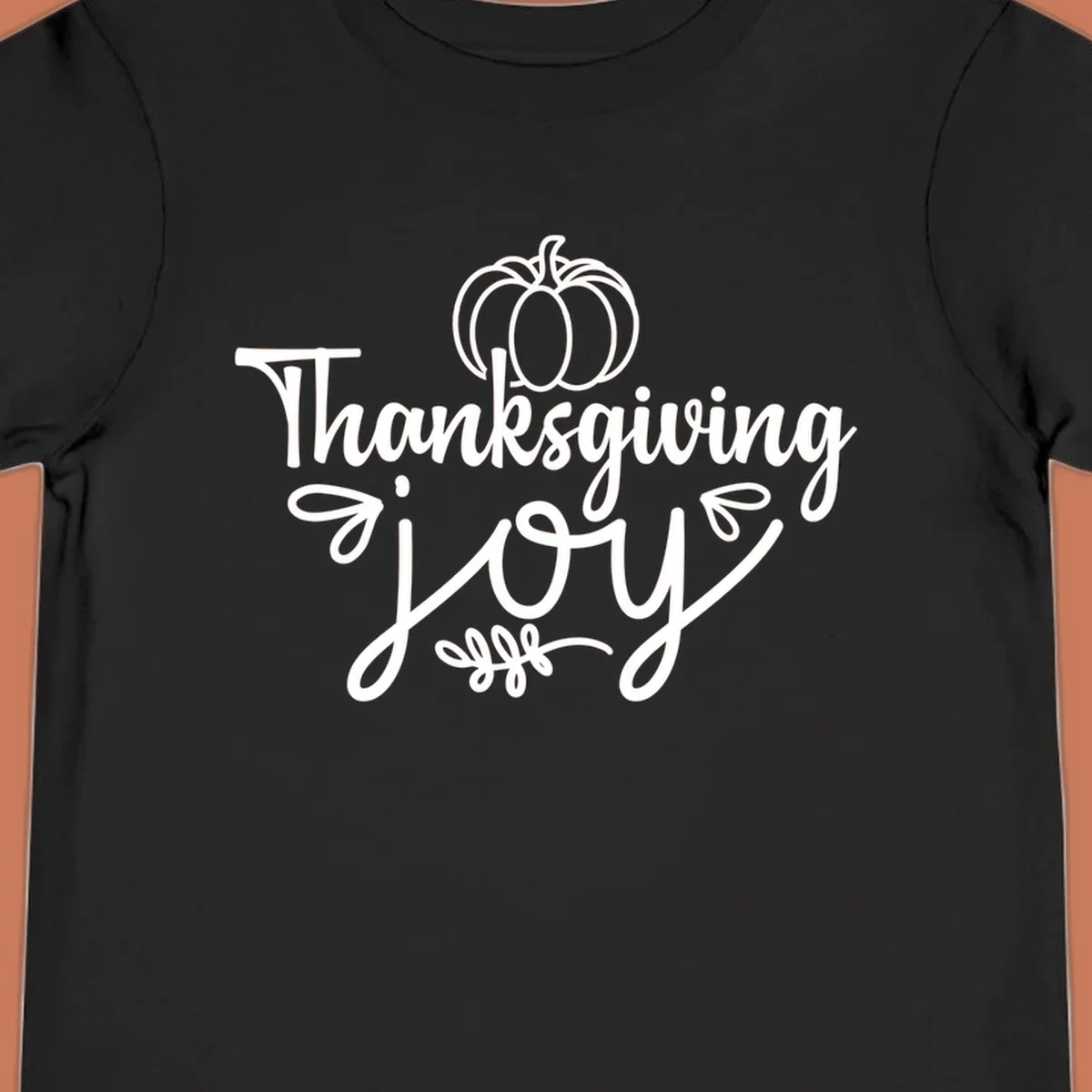 Thanksgiving Joy script text with a pumpkin illustration, for gratitude tees.