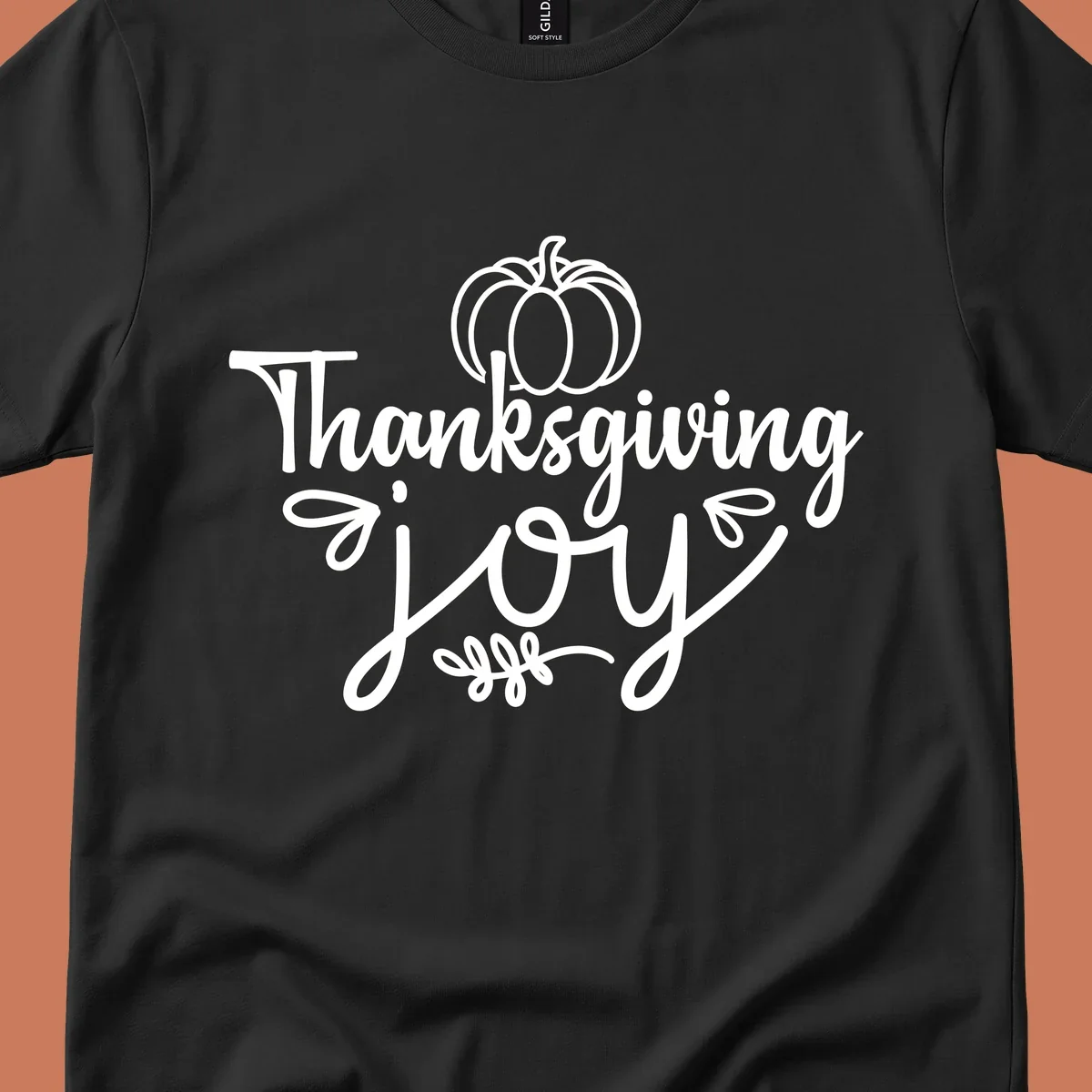 Thanksgiving Joy script text with a pumpkin illustration, for gratitude tees.