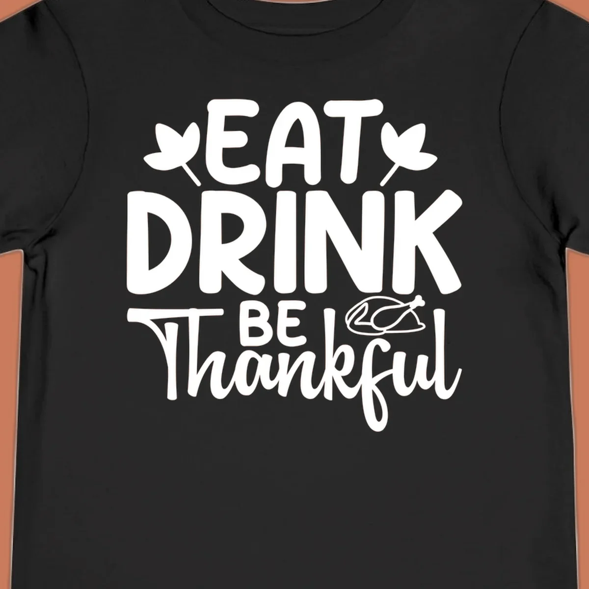 Eat Drink Be Thankful text with autumn leaves and a roasted chicken graphic.