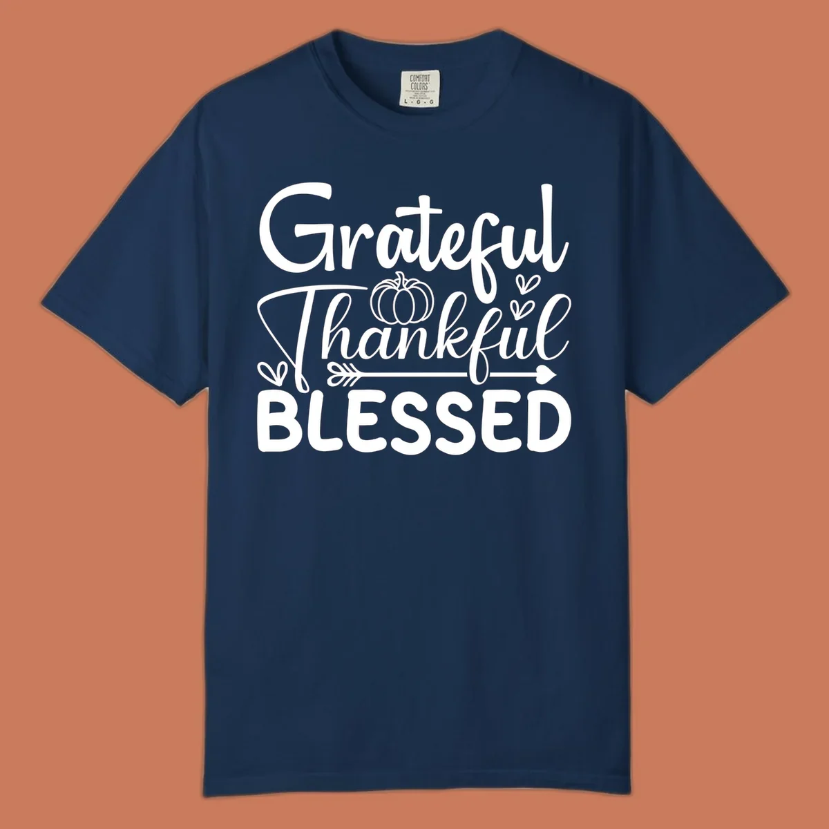 Grateful Thankful Blessed typography design with pumpkin, hearts, and arrow.