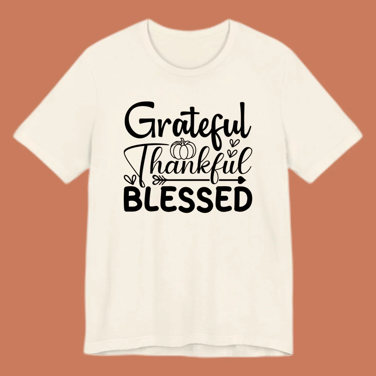 Grateful Thankful Blessed typography design with pumpkin, hearts, and arrow.