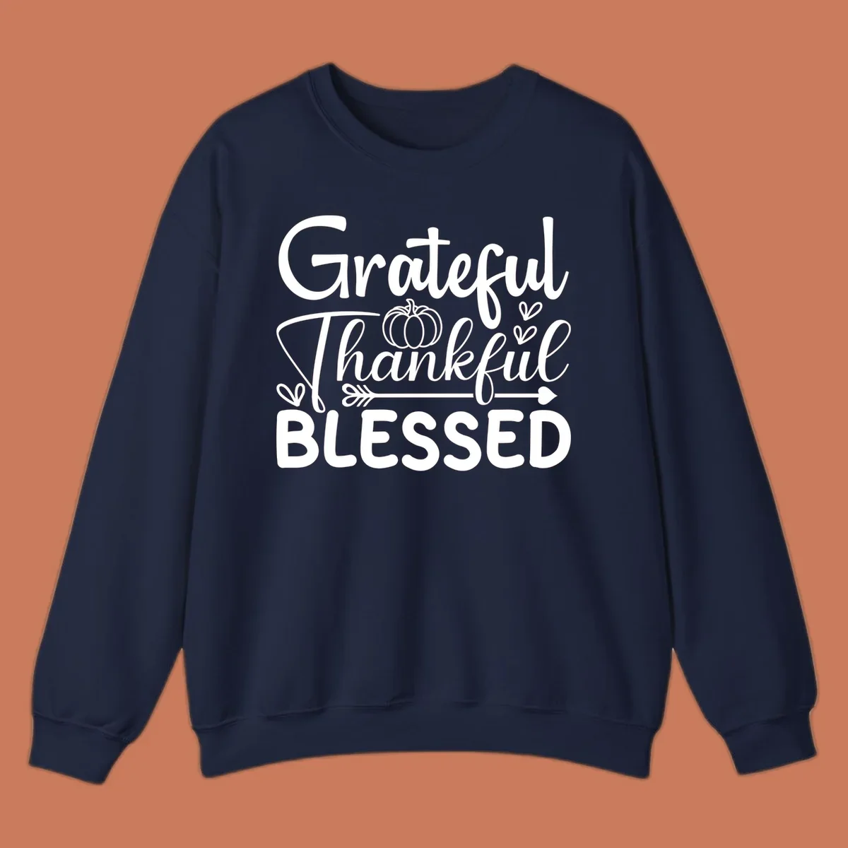 Grateful Thankful Blessed typography design with pumpkin, hearts, and arrow.