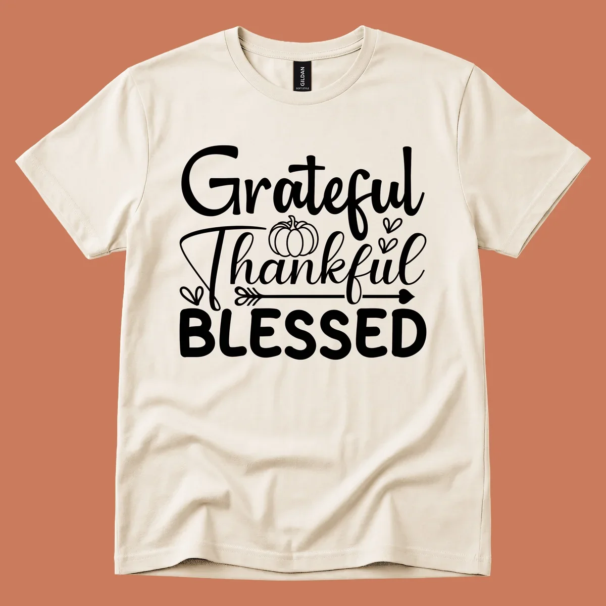 Grateful Thankful Blessed typography design with pumpkin, hearts, and arrow.