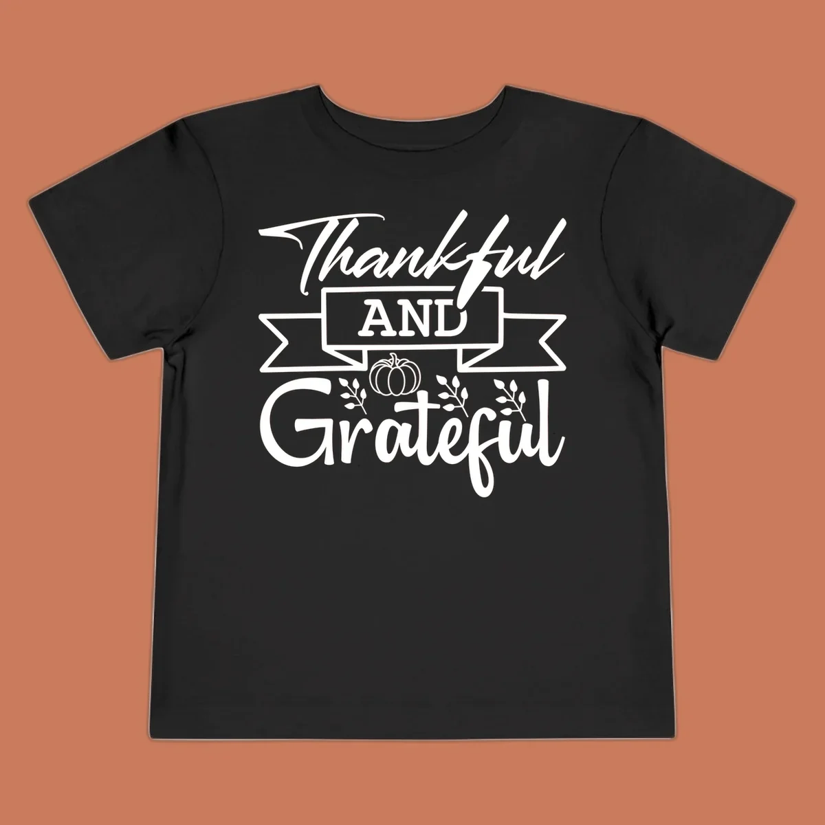 Thankful and Grateful autumn design with pumpkin and leaves.