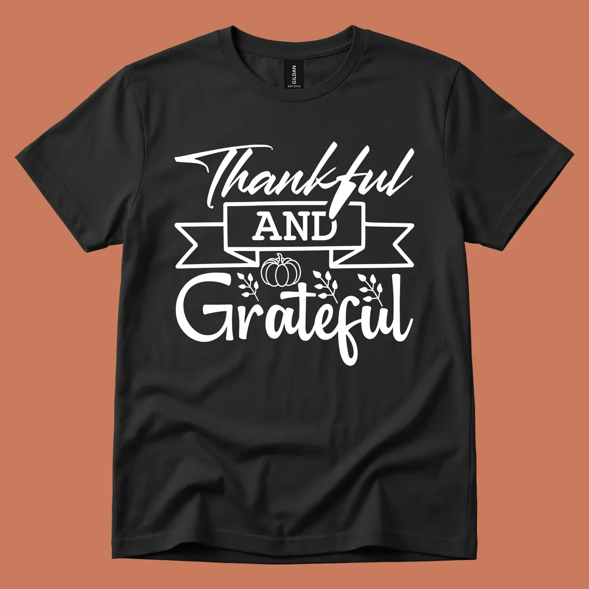 Thankful and Grateful autumn design with pumpkin and leaves.