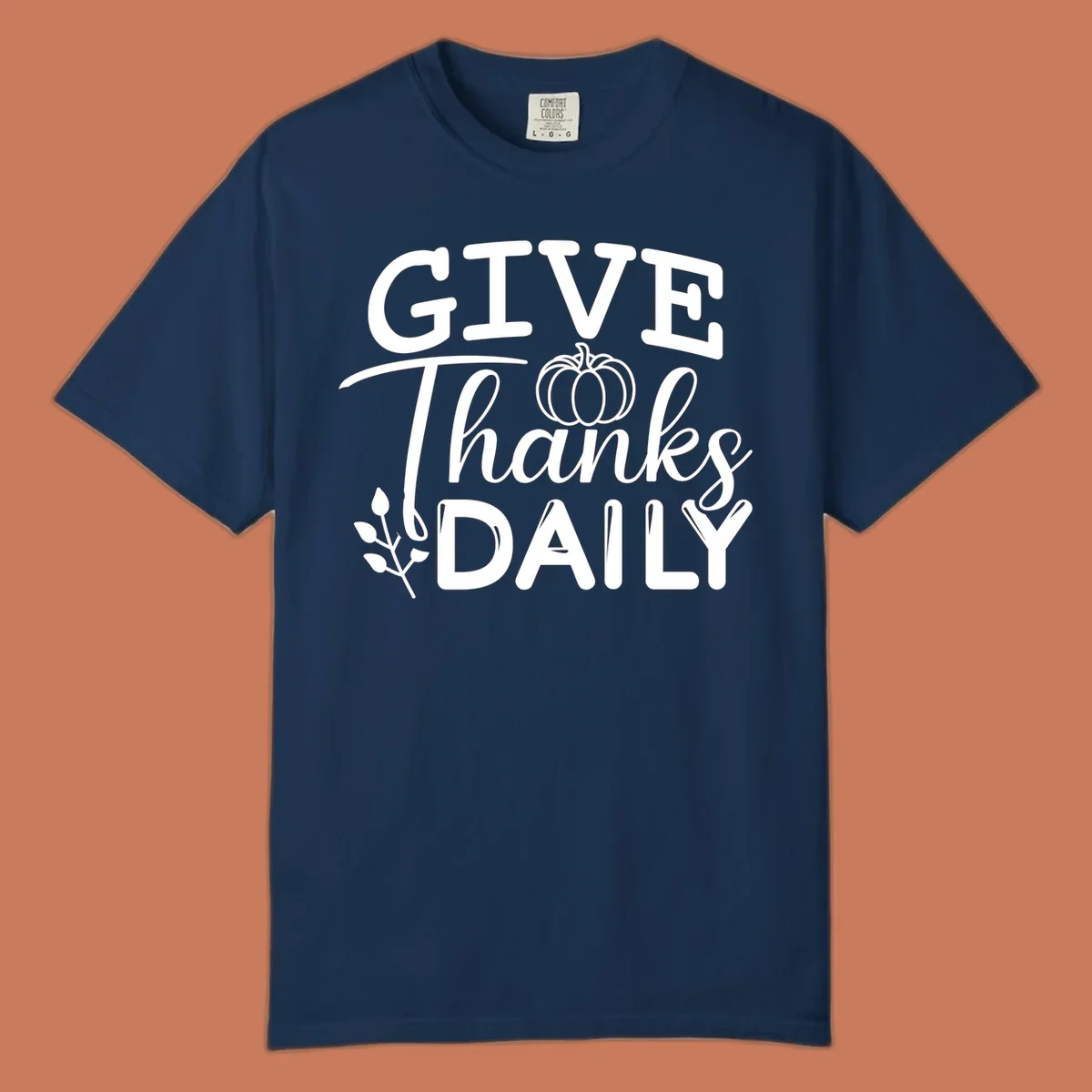 Give Thanks Daily text with a pumpkin and leaf sprig.