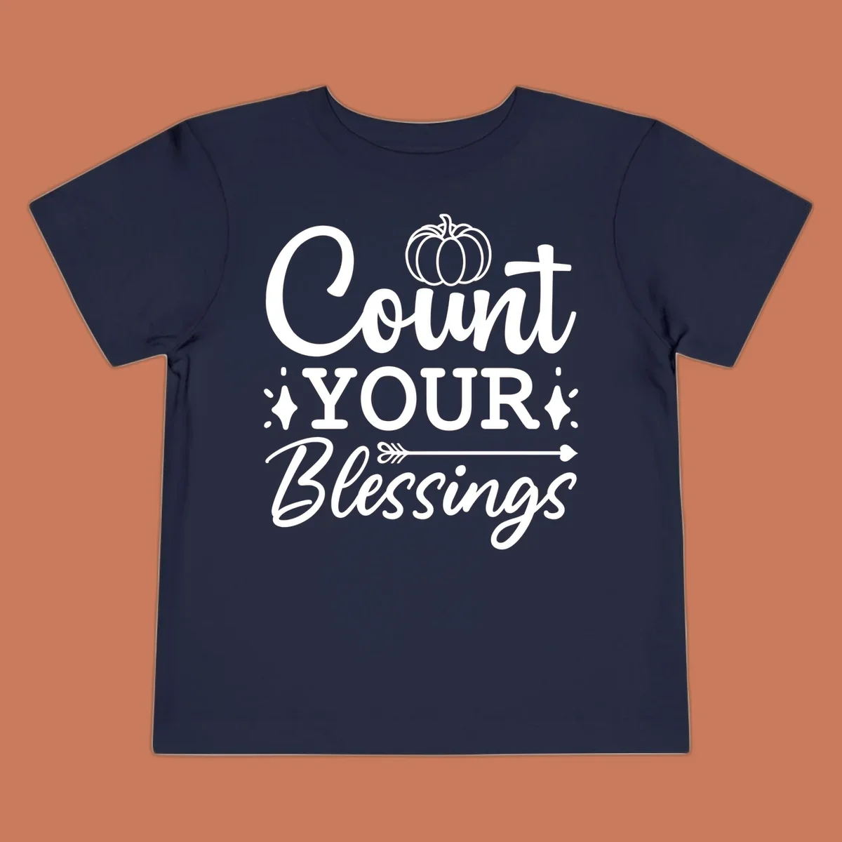 Count your blessings text with pumpkin and arrow graphic, in white.