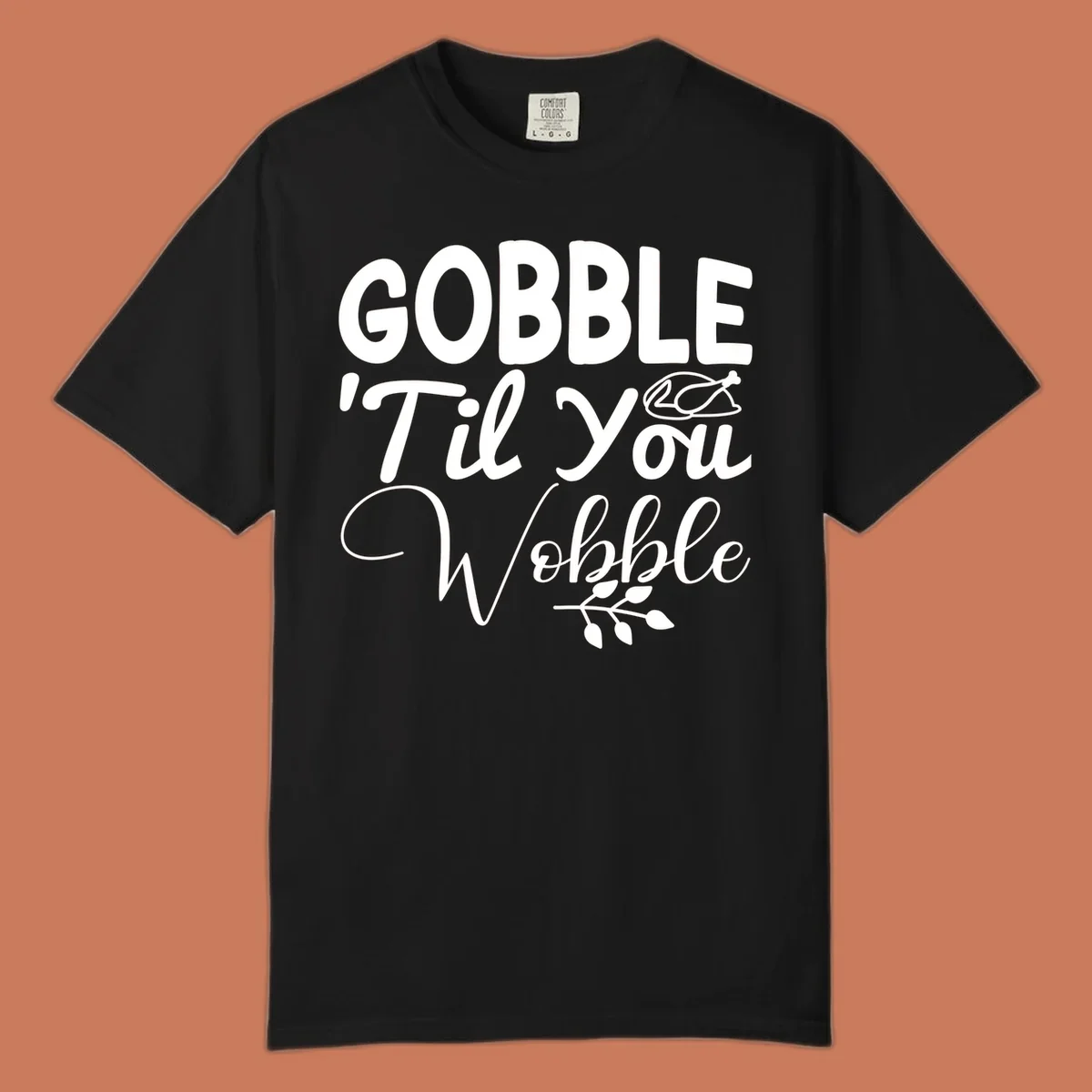 Gobble wobble thanksgiving phrase with roasted turkey illustration and leafy branch.