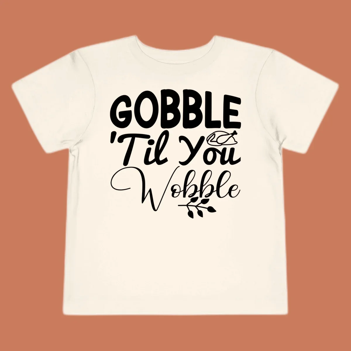 Gobble wobble thanksgiving phrase with roasted turkey illustration and leafy branch.