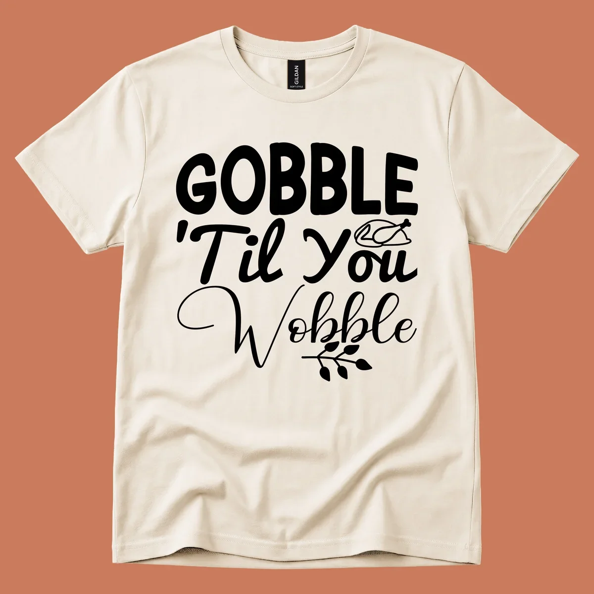 Gobble wobble thanksgiving phrase with roasted turkey illustration and leafy branch.