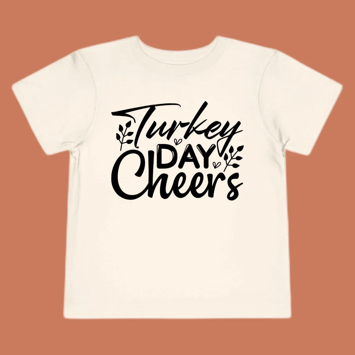 Typography design with "Turkey DAY Cheers" and decorative leaves, a Thanksgiving sentiment.