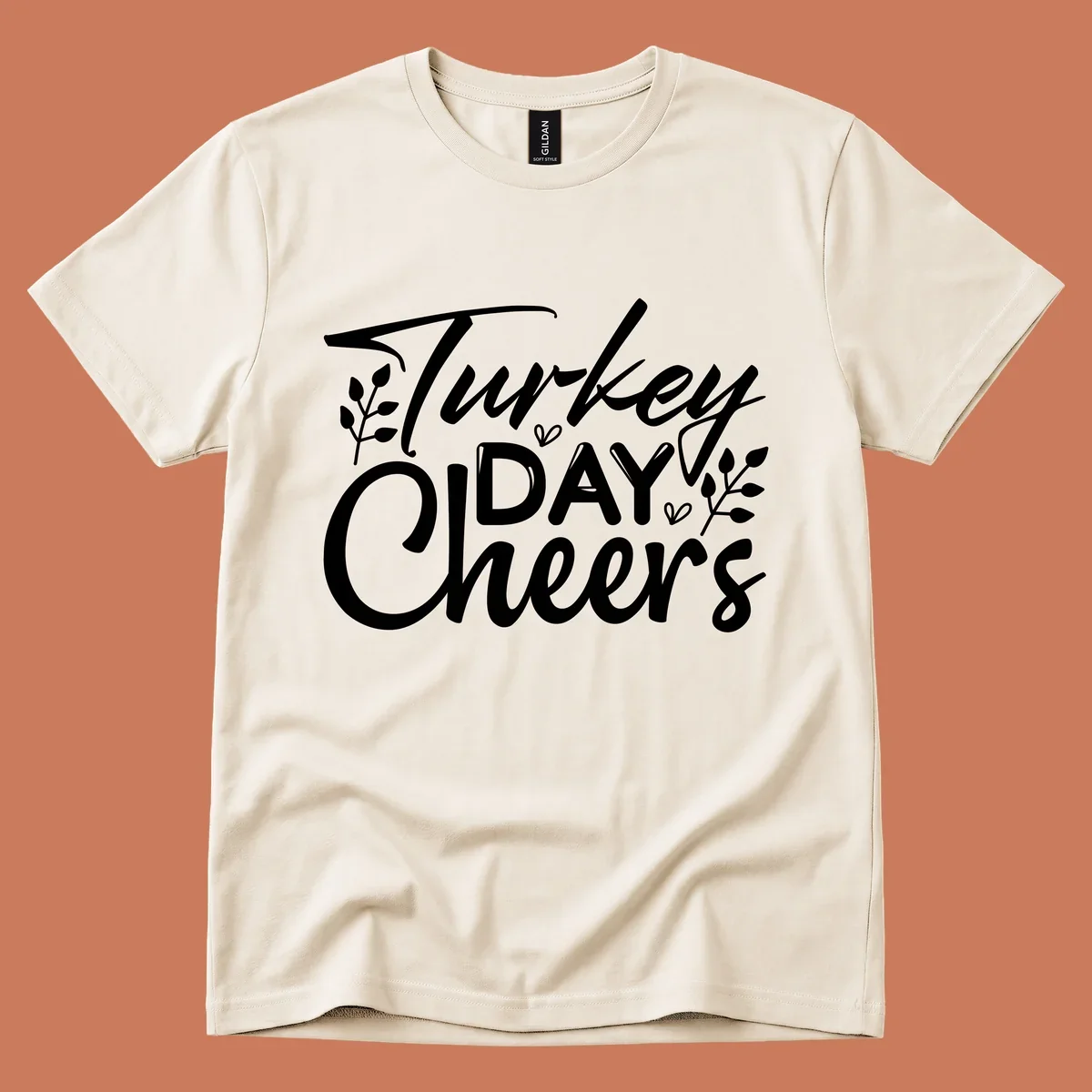 Typography design with "Turkey DAY Cheers" and decorative leaves, a Thanksgiving sentiment.