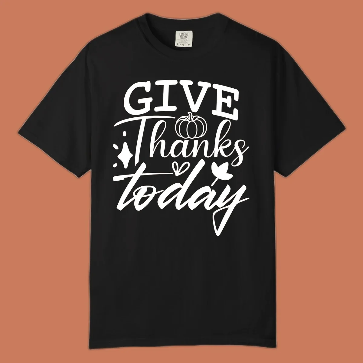 Give Thanks Today typography design with pumpkin and leaf elements.