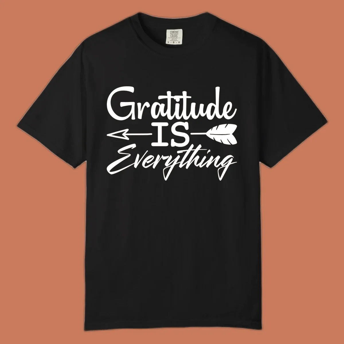 Gratitude Is Everything typography design with an arrow and feather graphic.