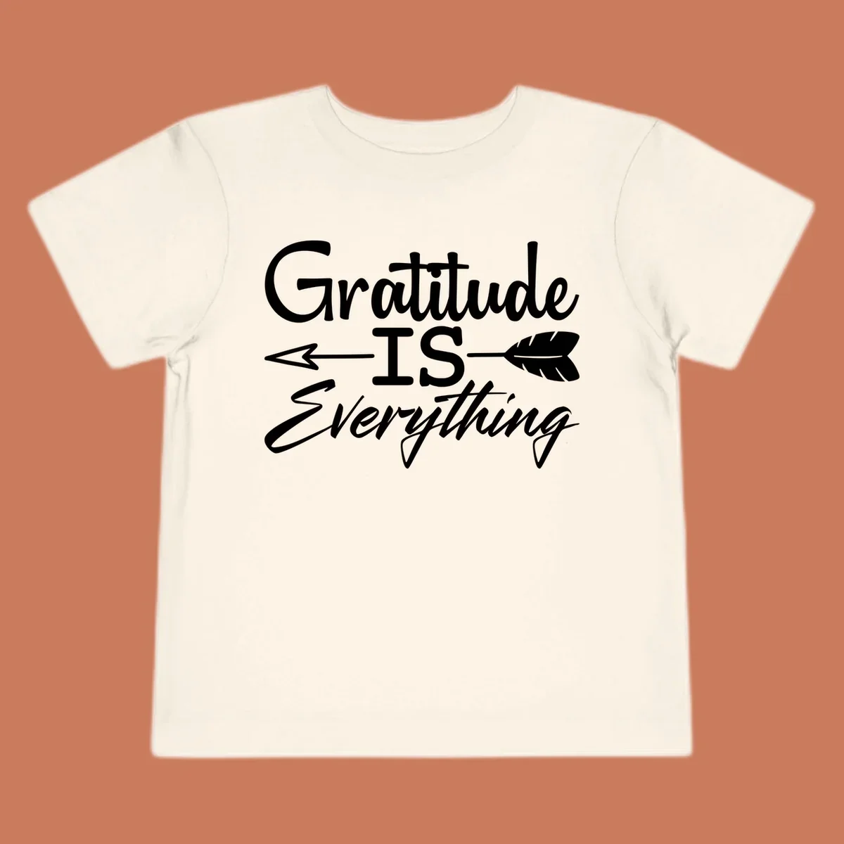 Gratitude Is Everything typography design with an arrow and feather graphic.