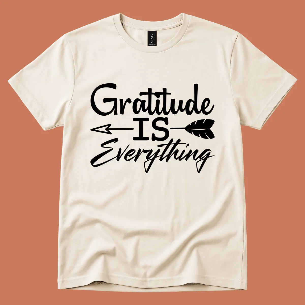 Gratitude Is Everything typography design with an arrow and feather graphic.