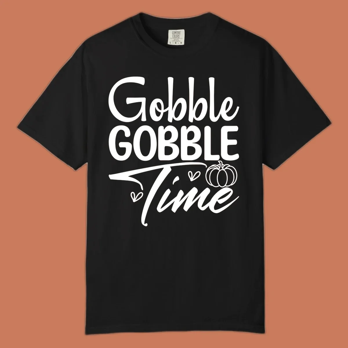 Gobble Gobble Time phrase with pumpkin and hearts, white typography on black background.