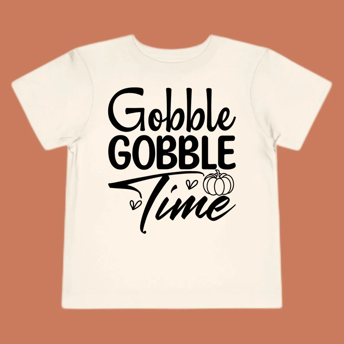 Gobble Gobble Time phrase with pumpkin and hearts, white typography on black background.