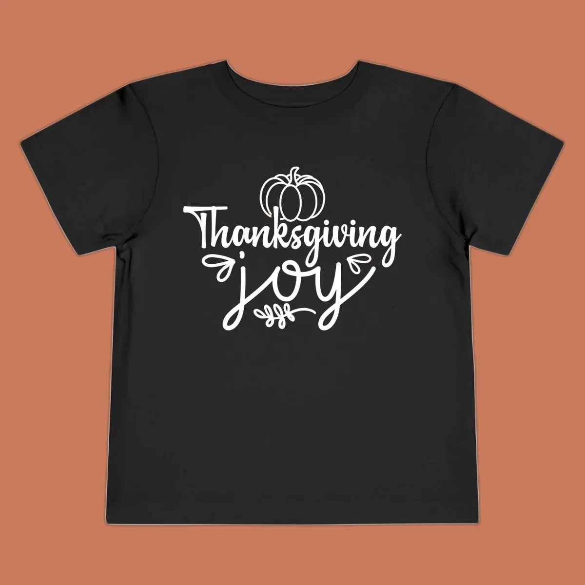 Thanksgiving Joy script text with a pumpkin illustration, for gratitude tees.