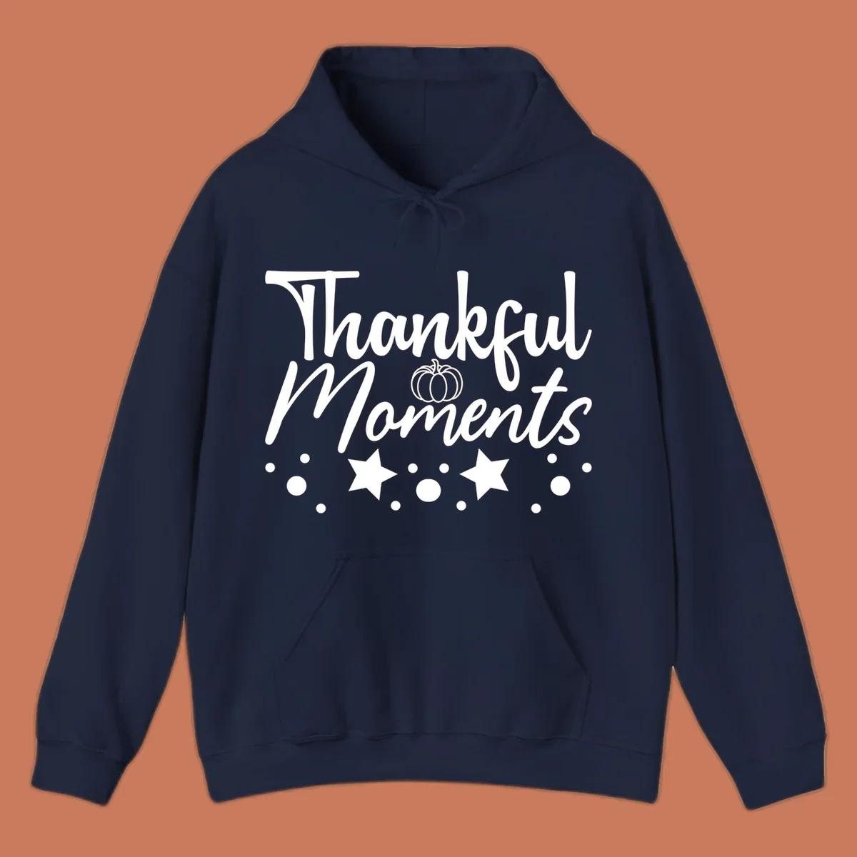 Thankful Moments autumn script text with pumpkin, stars, and dots graphic.
