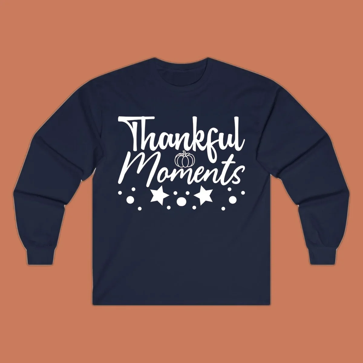 Thankful Moments autumn script text with pumpkin, stars, and dots graphic.