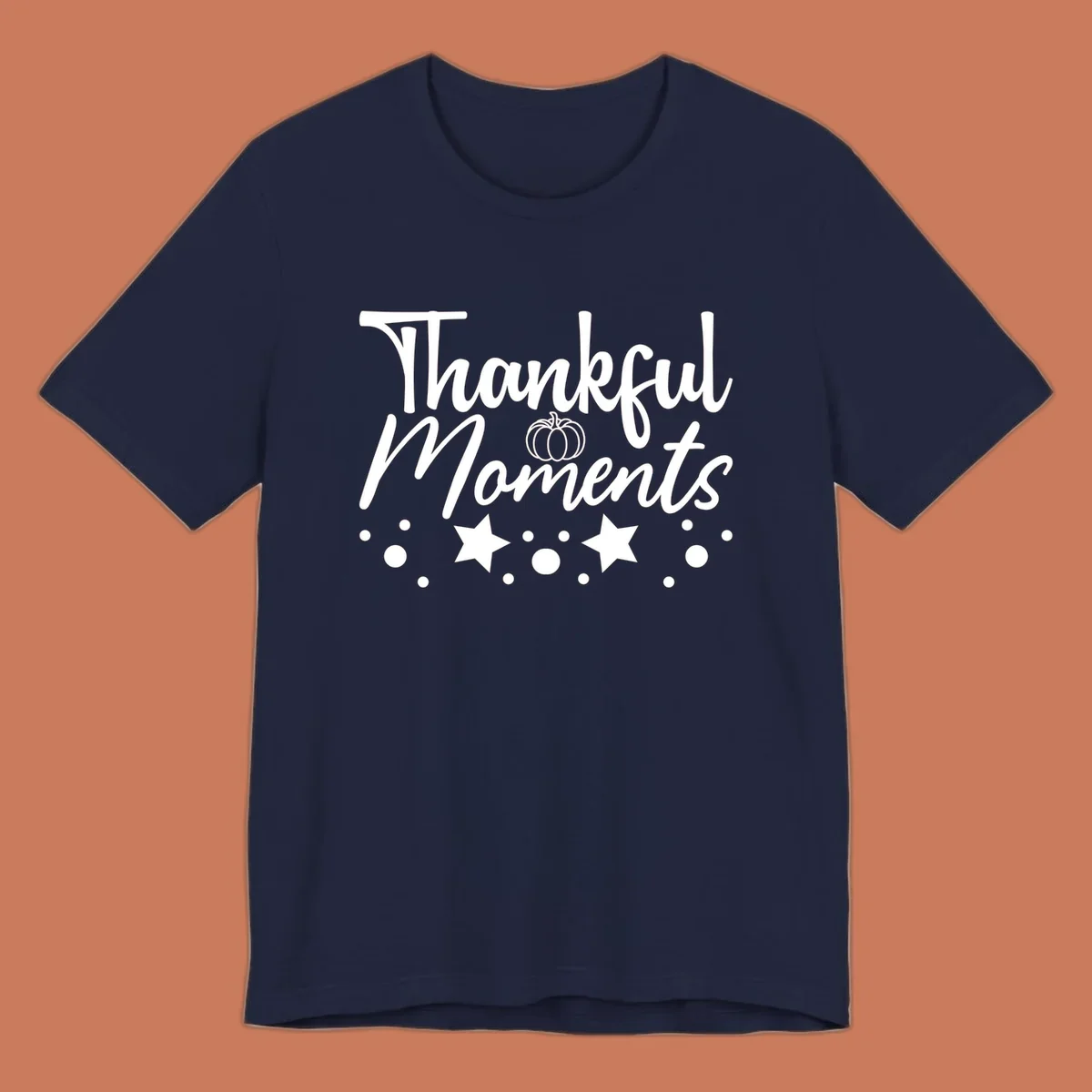 Thankful Moments autumn script text with pumpkin, stars, and dots graphic.