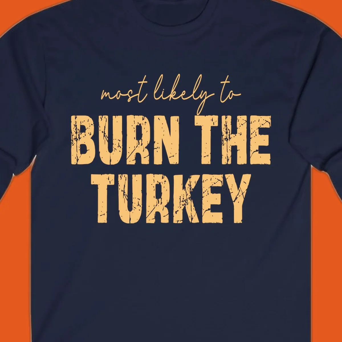 Most likely to burn the turkey text design in distressed orange and tan.
