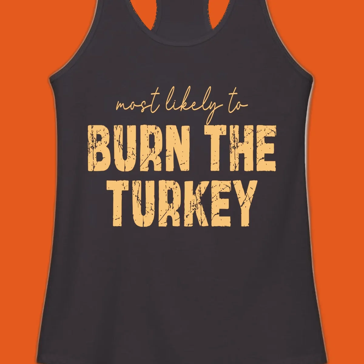 Most likely to burn the turkey text design in distressed orange and tan.
