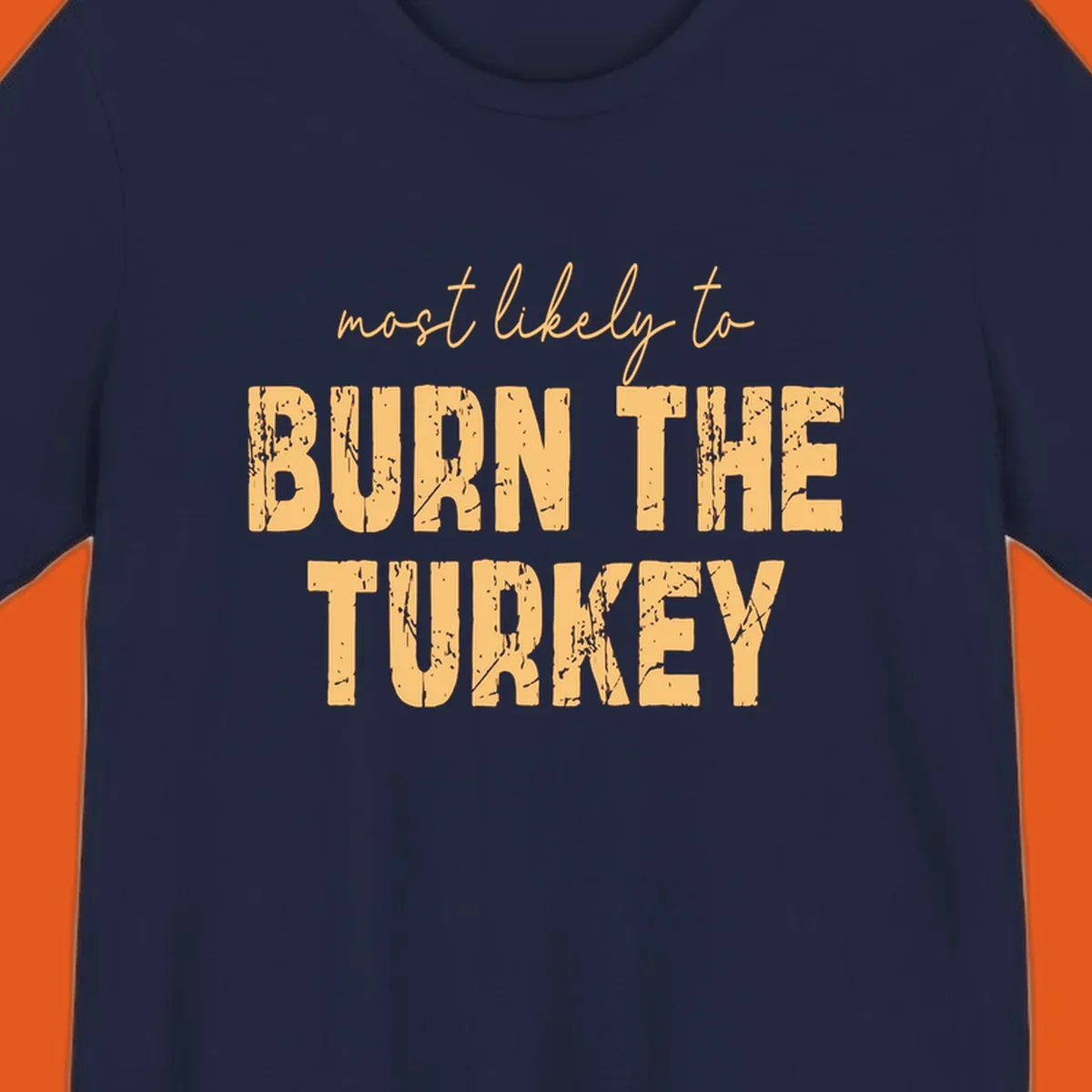 Most likely to burn the turkey text design in distressed orange and tan.
