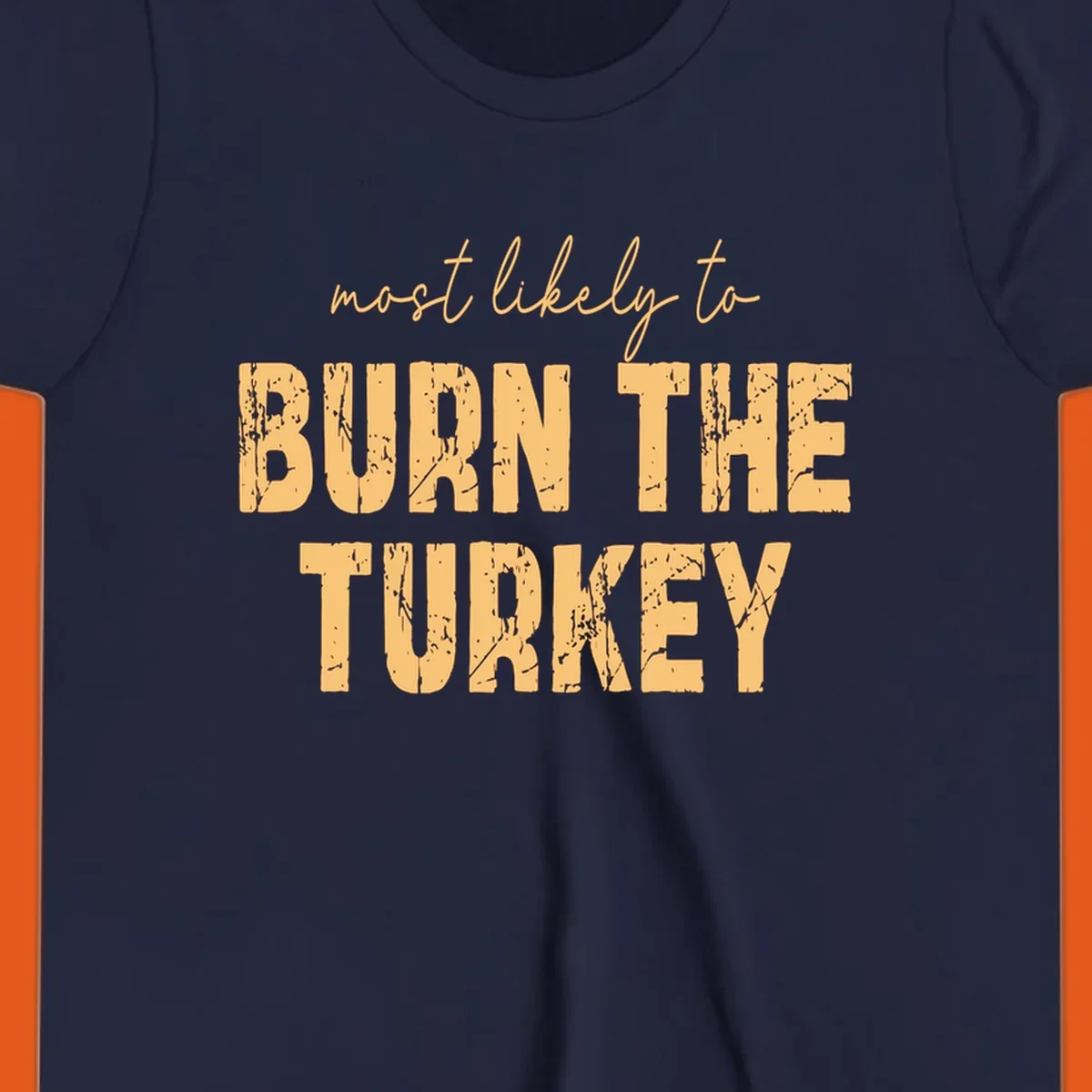 Most likely to burn the turkey text design in distressed orange and tan.