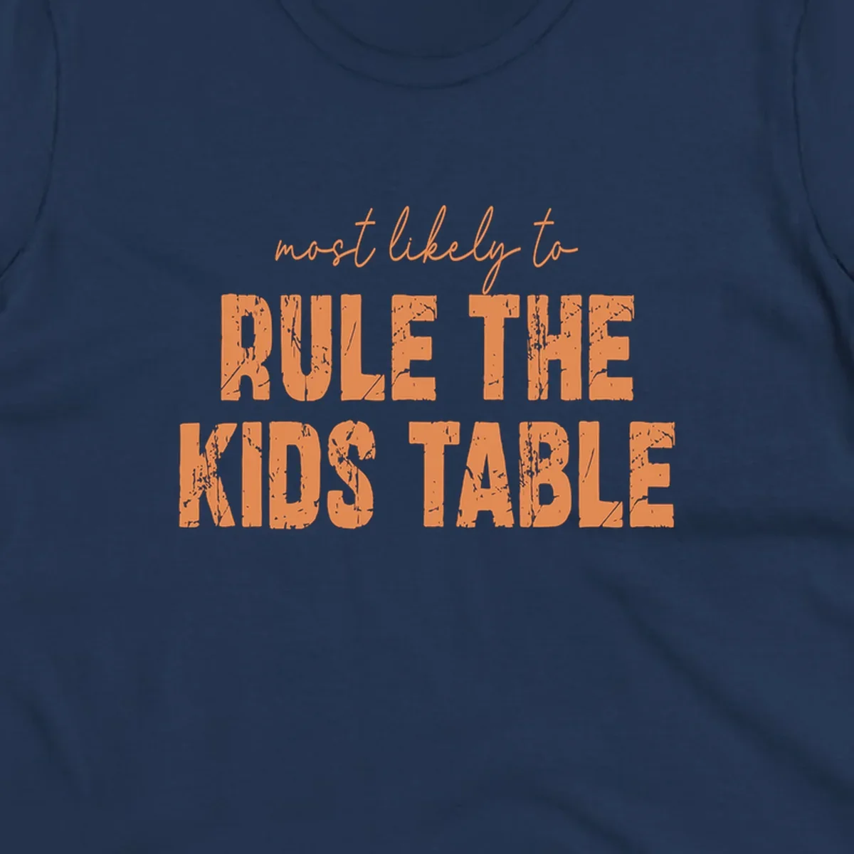 Text design 'most likely to rule the kids table' in distressed orange font.
