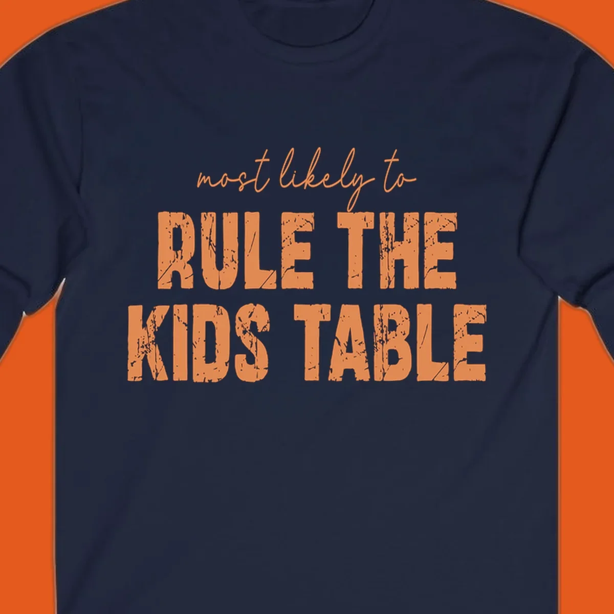 Text design 'most likely to rule the kids table' in distressed orange font.