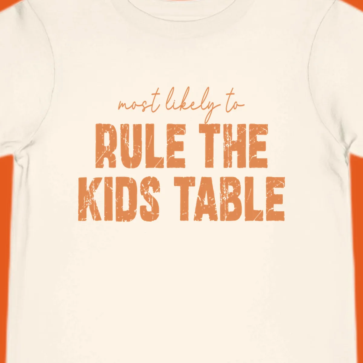 Text design 'most likely to rule the kids table' in distressed orange font.