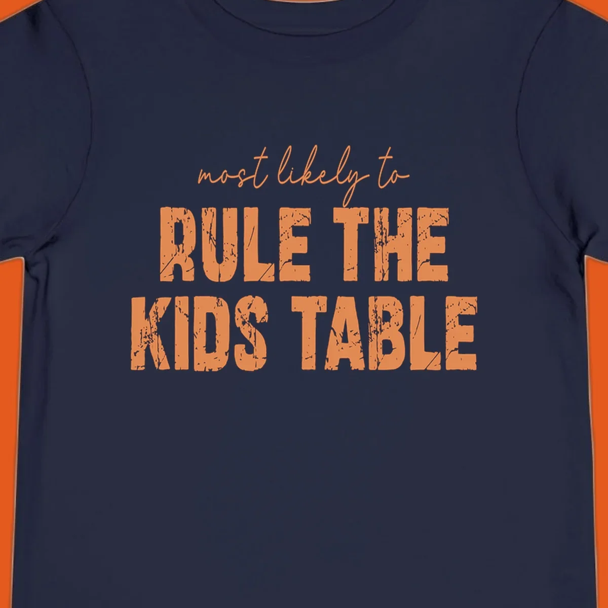 Text design 'Most Likely to Rule the Kids Table' in distressed orange font.