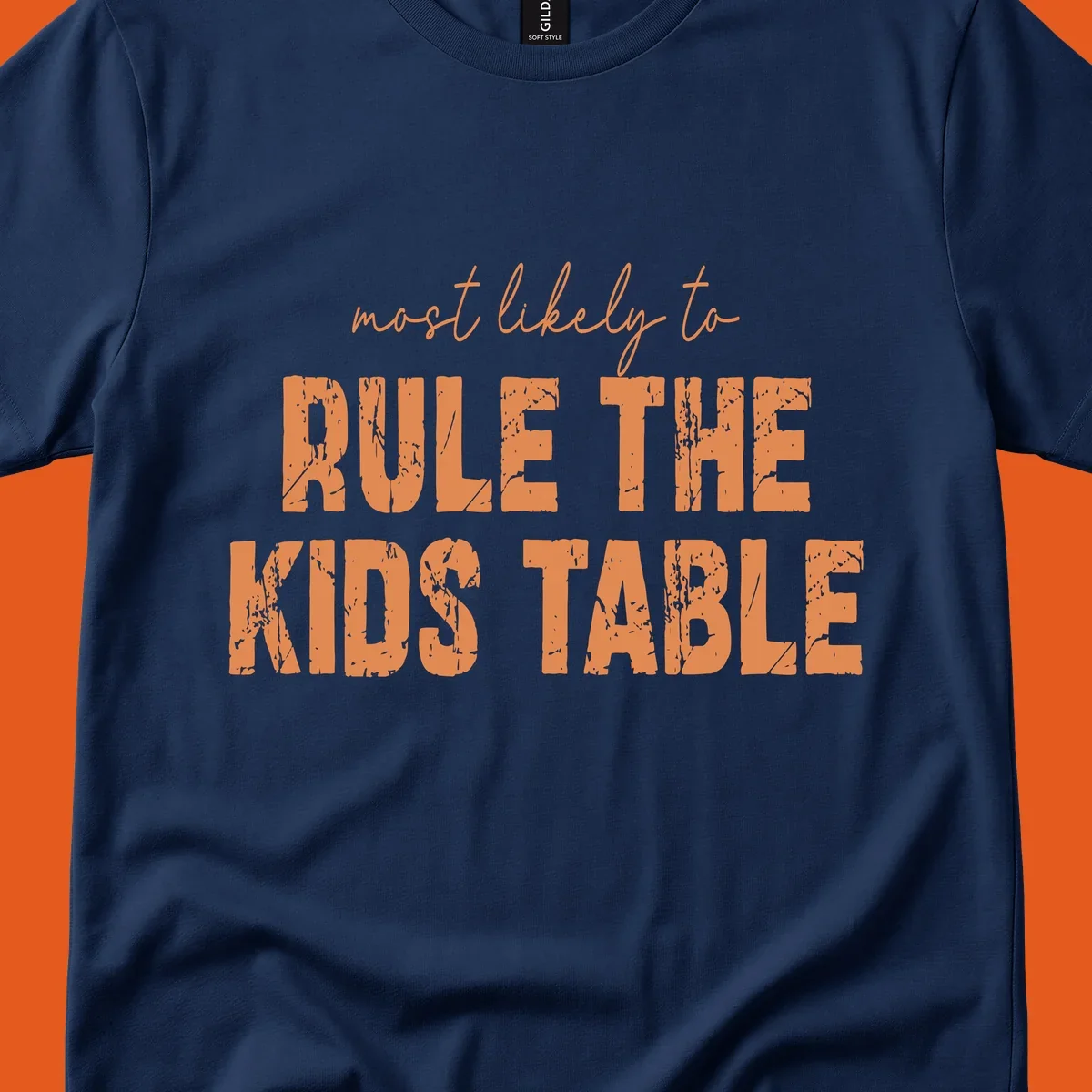 Text design 'Most Likely to Rule the Kids Table' in distressed orange font.