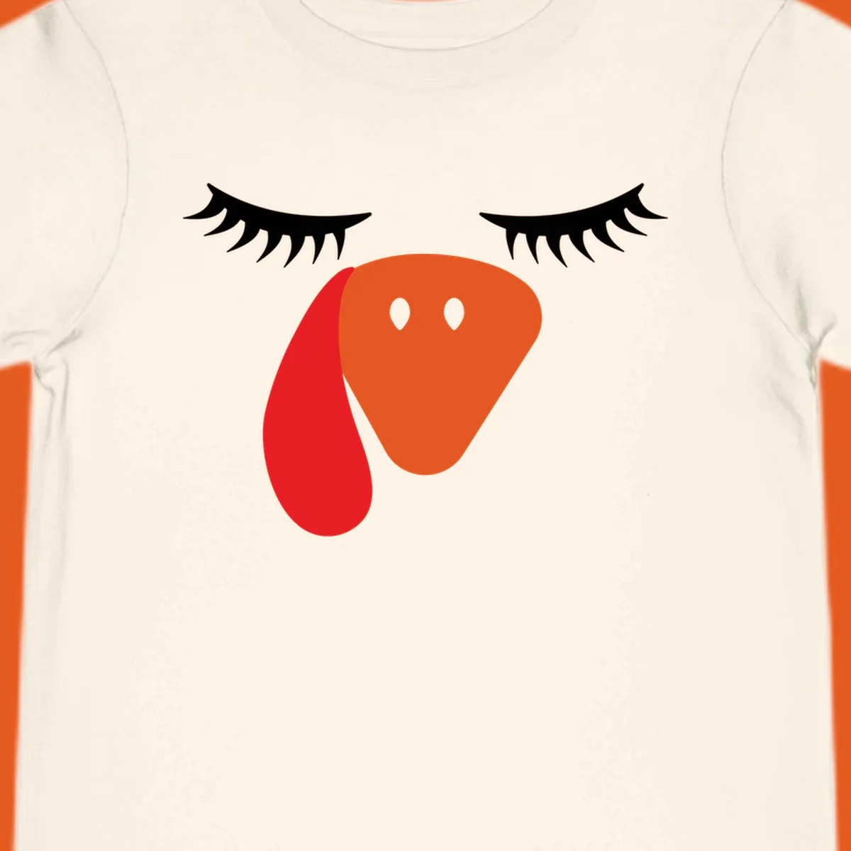 Funny turkey face graphic with closed eyes and eyelashes, perfect for Turkey Trot shirts.