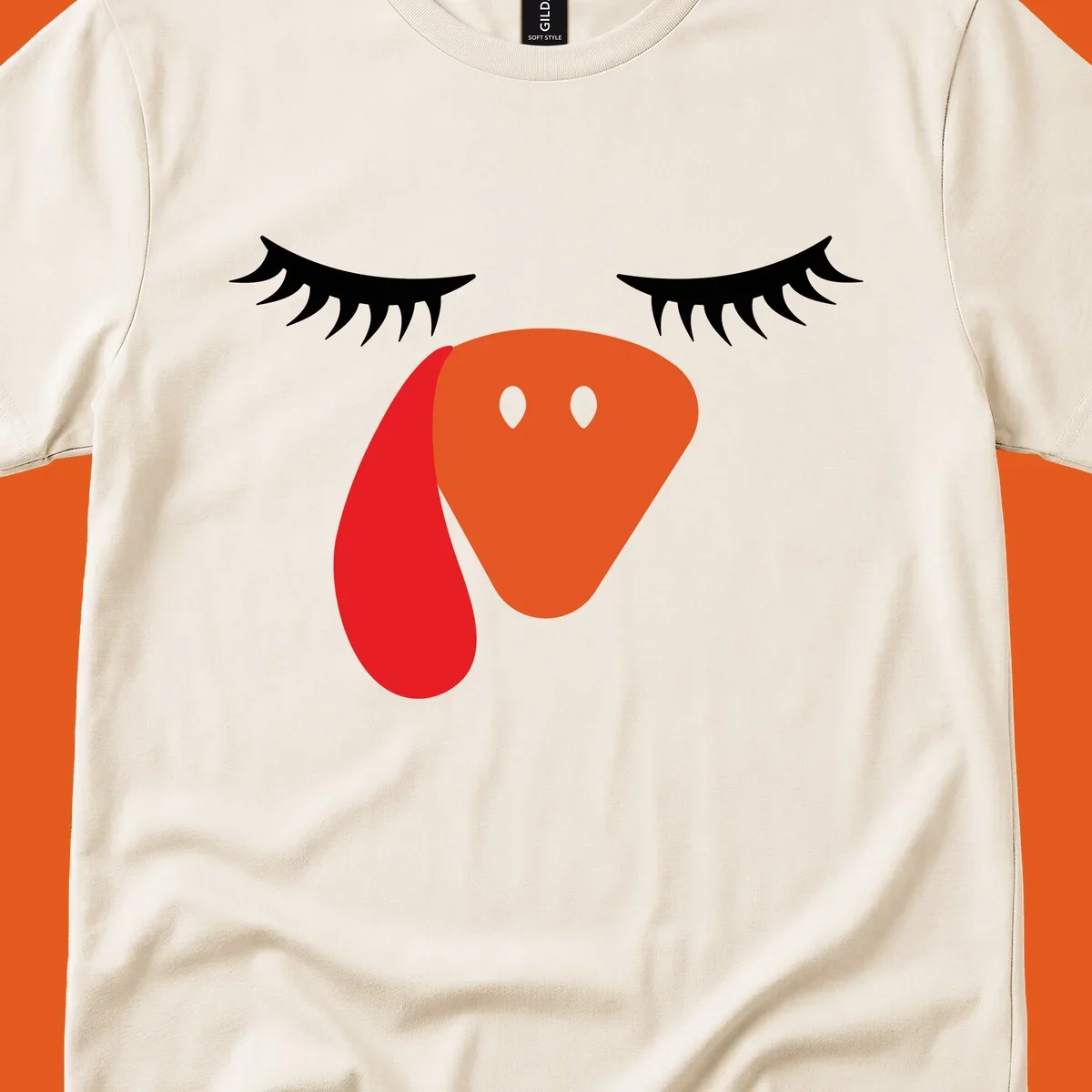 Funny turkey face graphic with closed eyes and eyelashes, perfect for Turkey Trot shirts.