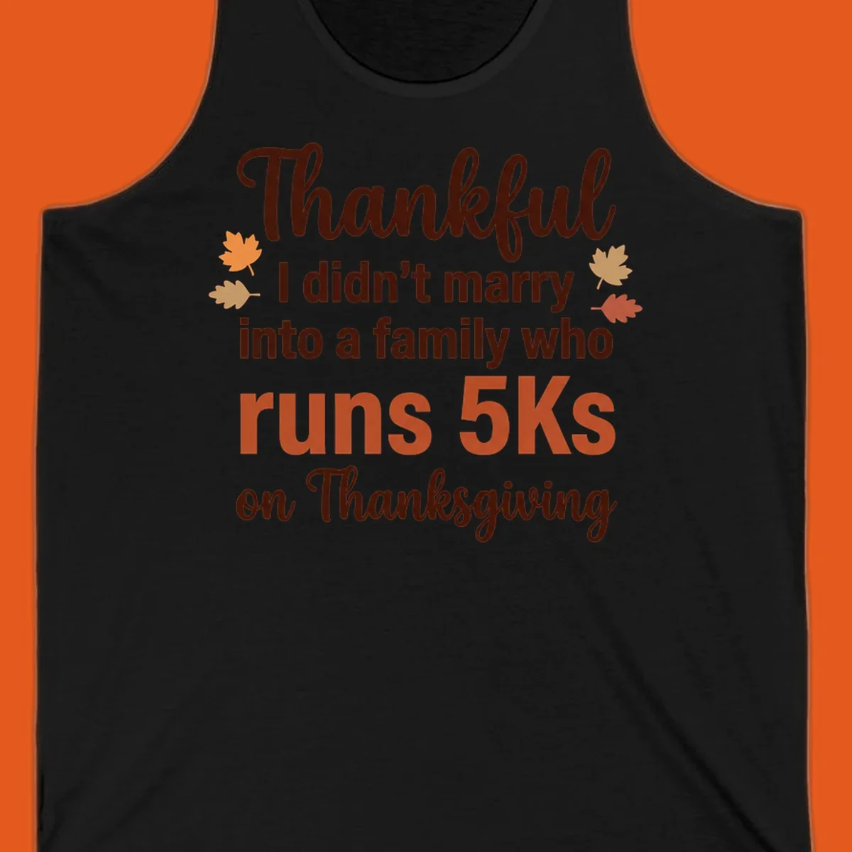 Text design 'Thankful I didn't marry into a family who runs 5Ks on Thanksgiving' with autumn leaves, for Thanksgiving 5k runner.
