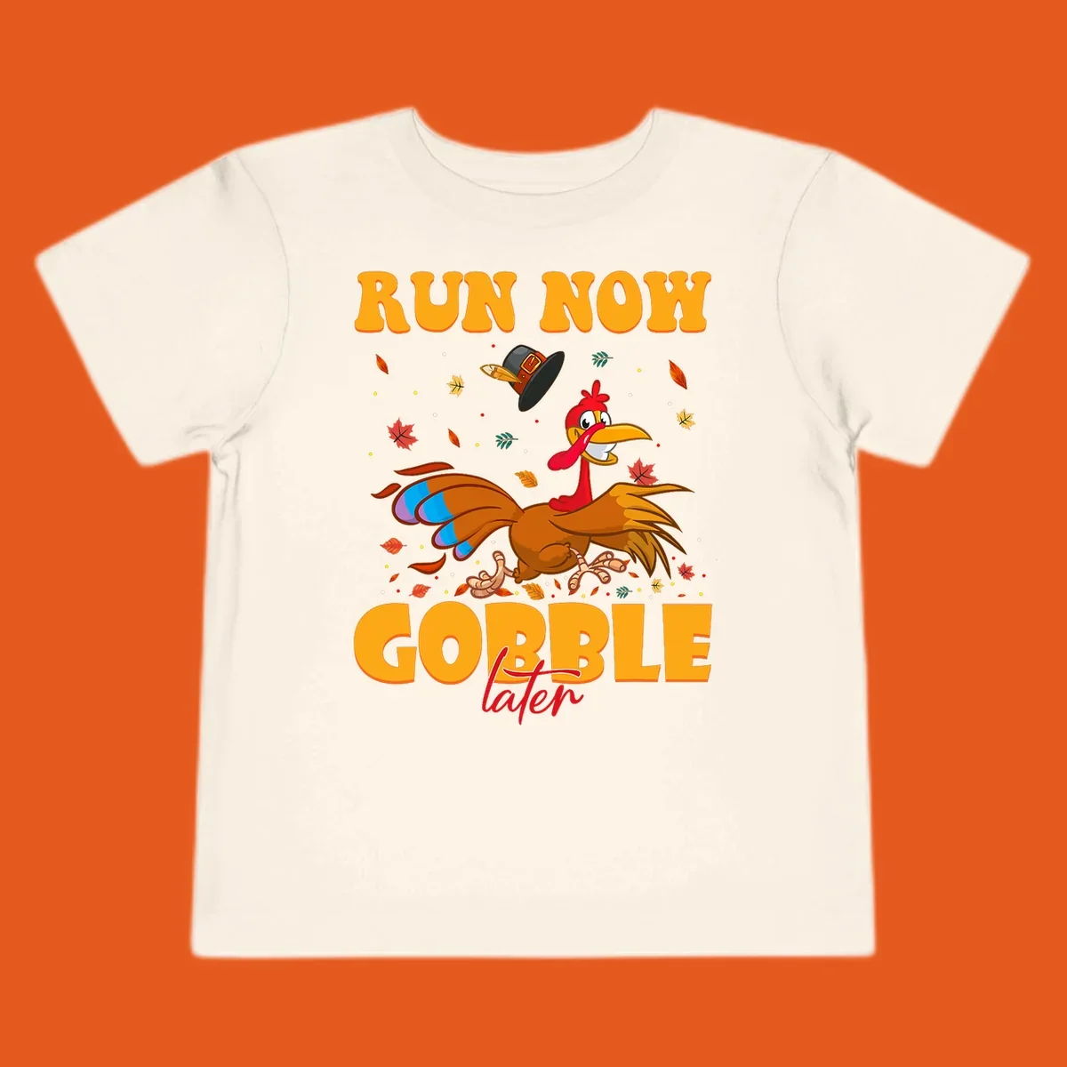 Cartoon turkey running with pilgrim hat, text "RUN NOW GOBBLE later" for Turkey Trot shirt.