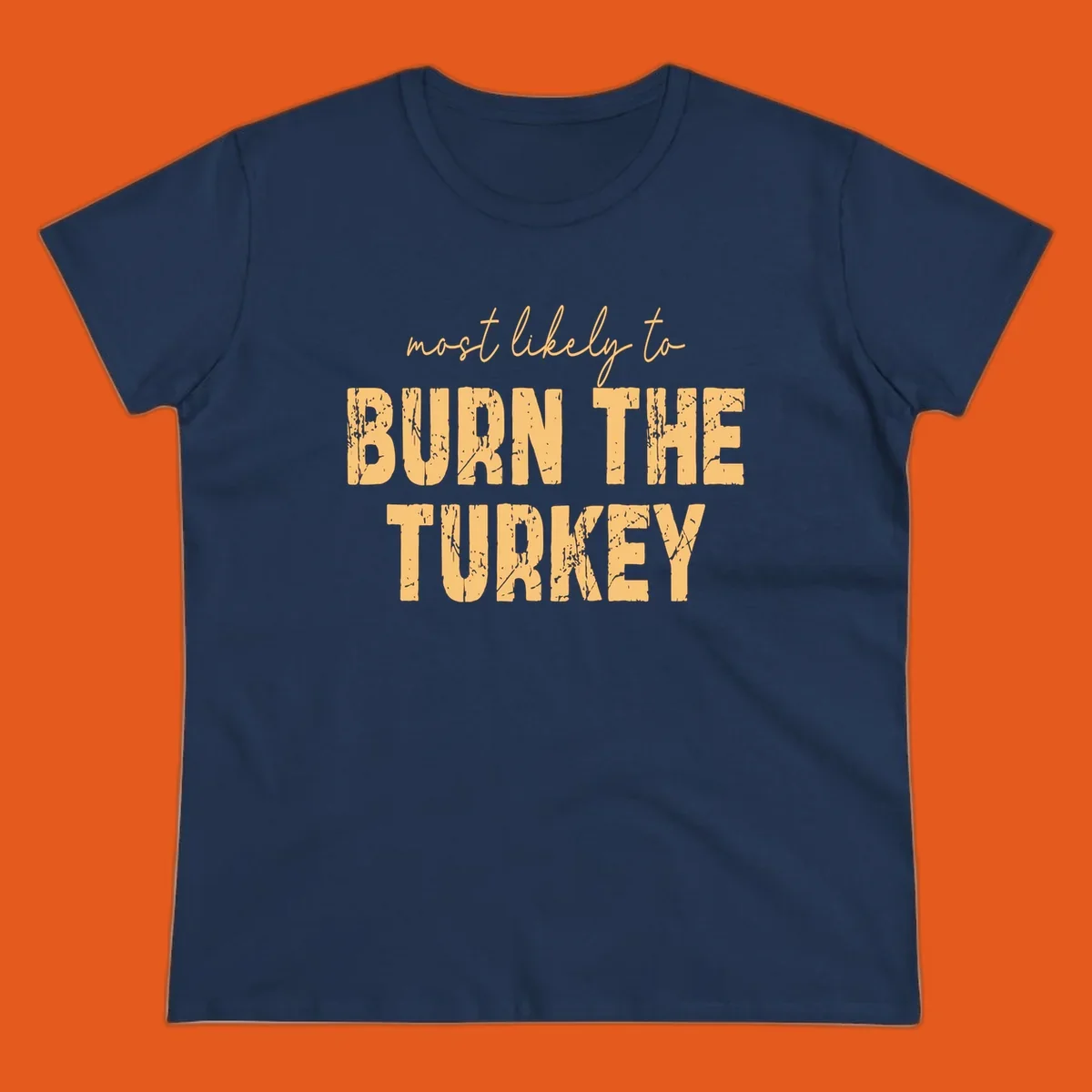 Most likely to burn the turkey text design in distressed orange and tan.