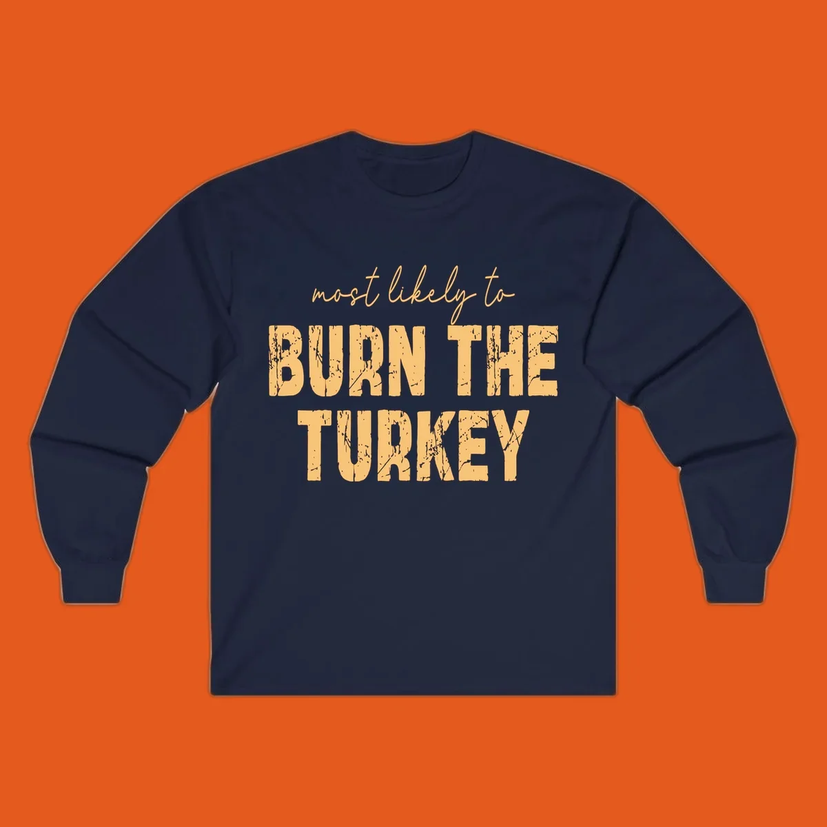 Most likely to burn the turkey text design in distressed orange and tan.