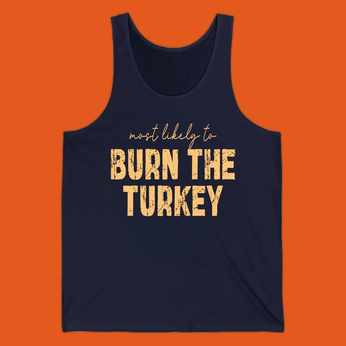 Most likely to burn the turkey text design in distressed orange and tan.