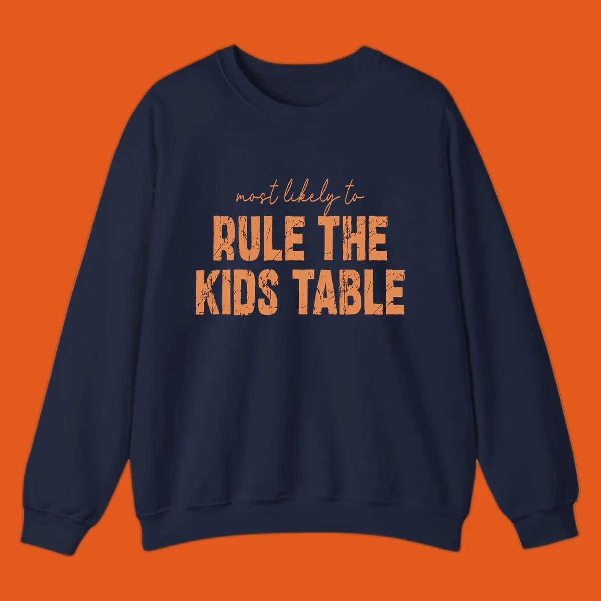 Text design 'most likely to rule the kids table' in distressed orange font.