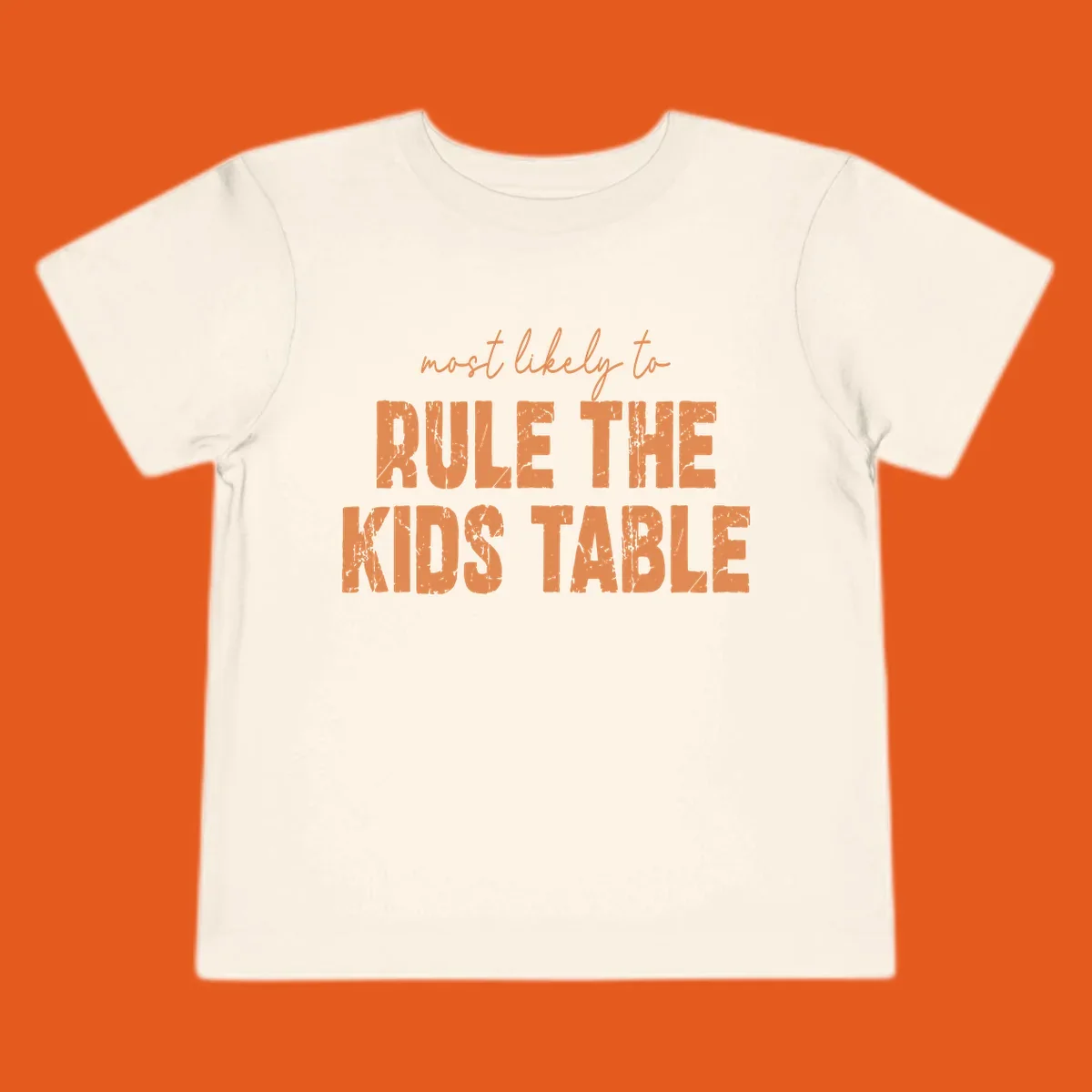 Text design 'most likely to rule the kids table' in distressed orange font.