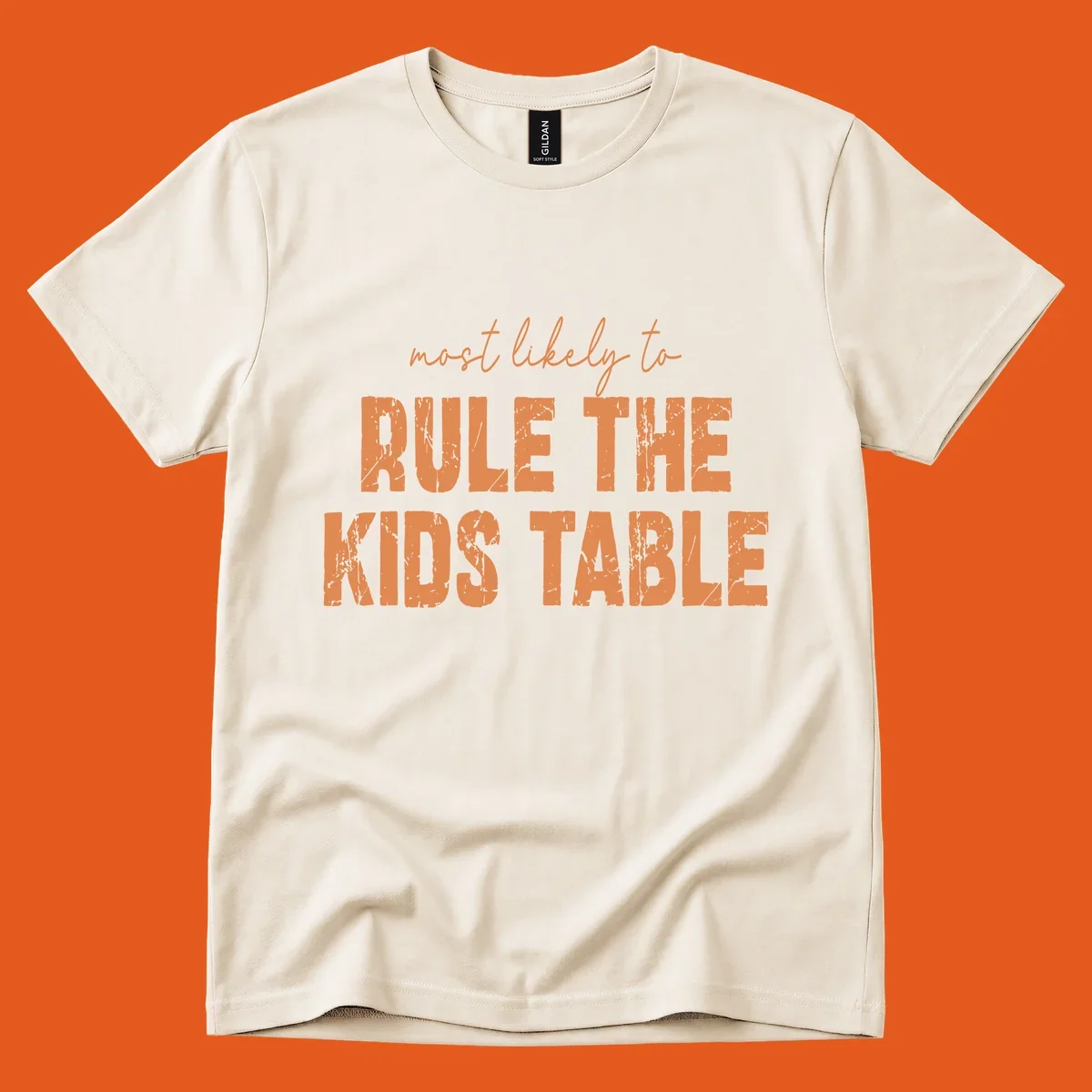 Text design 'most likely to rule the kids table' in distressed orange font.