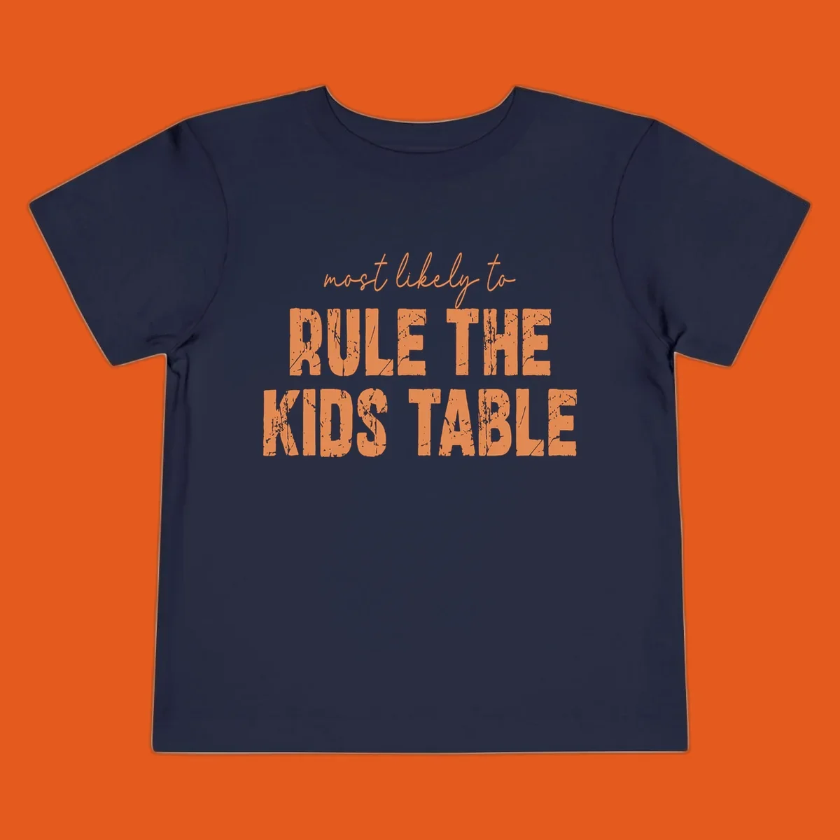 Text design 'Most Likely to Rule the Kids Table' in distressed orange font.