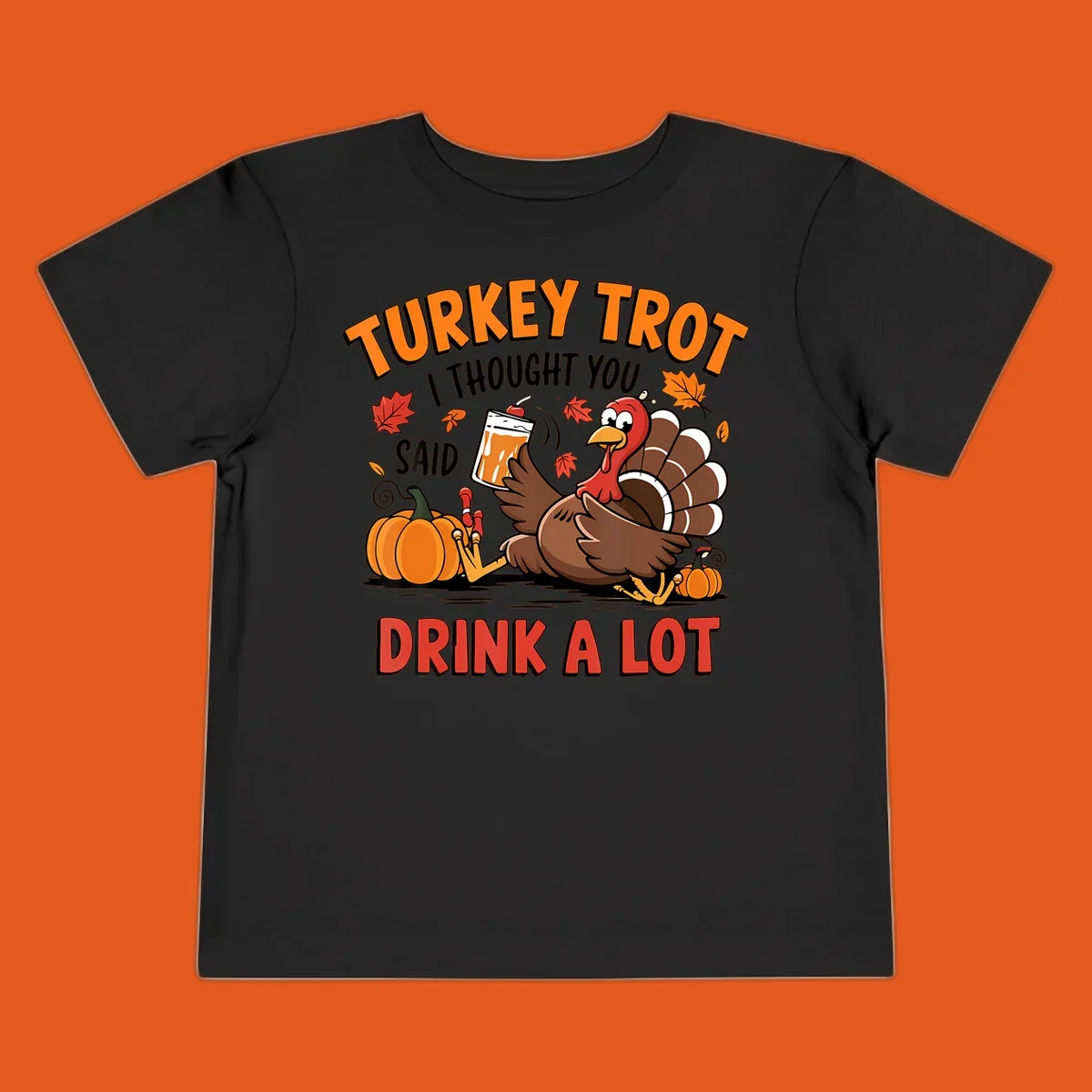 Illustration of a turkey with drink, pumpkins, and leaves, text: Turkey Trot I Thought You Said Drink A Lot.